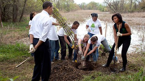 Obama watches Michelle plant a tree
